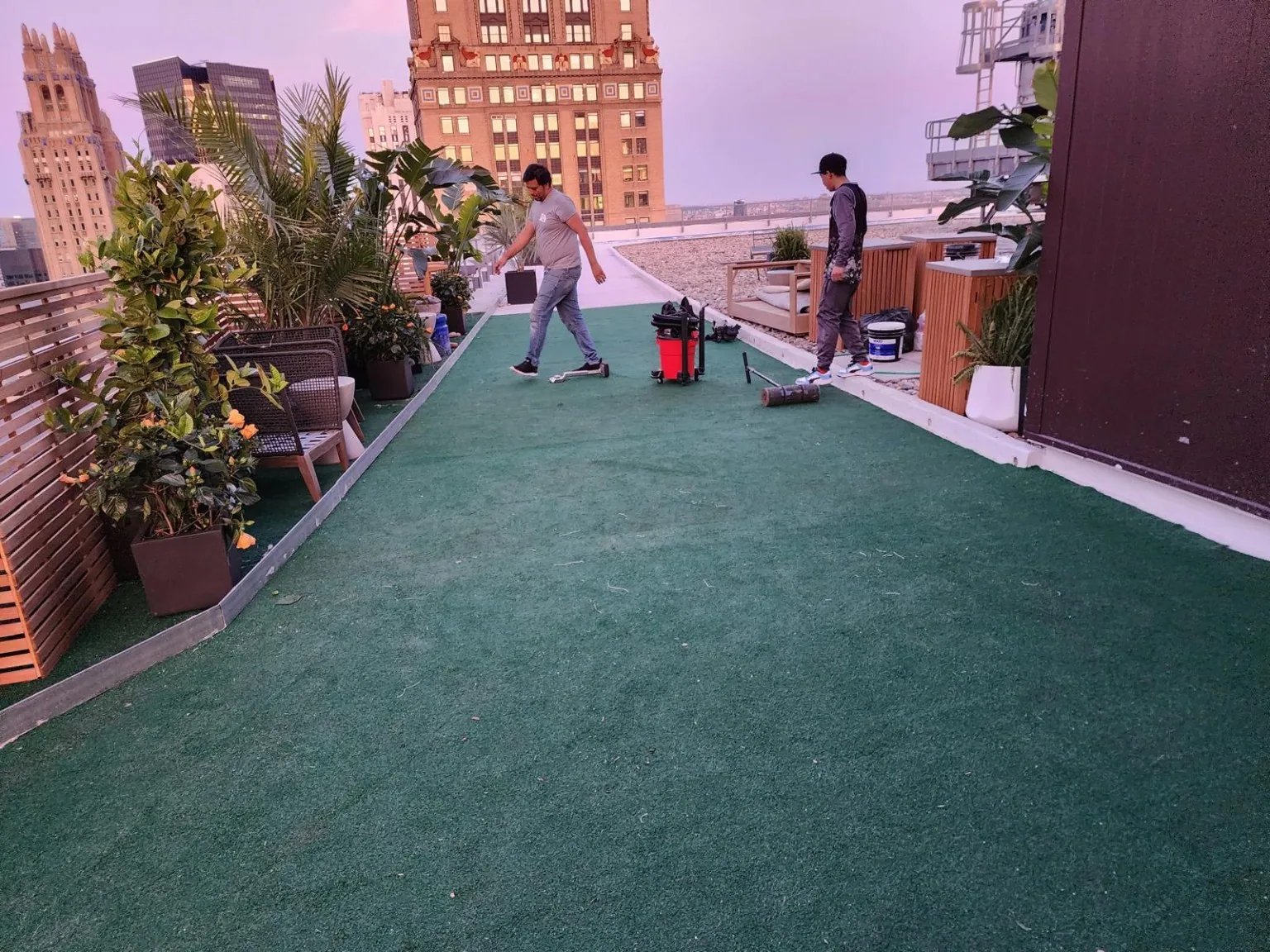 Flooring crew working on a rooftop turf installation