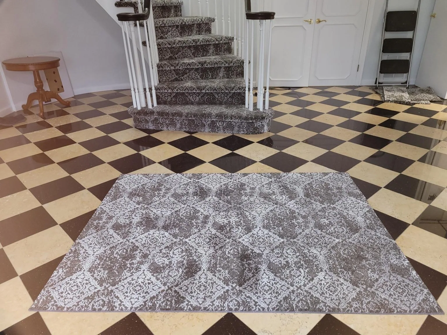 Front view of curved staircase with fitted patterned carpet